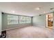 Spacious living room with light walls, neutral carpet, and large windows at 20735 Gardenia Dr, Land O Lakes, FL 34638
