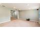 Open living room with neutral carpet and view into another room at 20735 Gardenia Dr, Land O Lakes, FL 34638