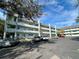 Front view of a light teal condominium building with ample parking at 2254 Norwegian Dr # 2, Clearwater, FL 33763