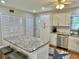 White kitchen with granite countertops, island, and stainless appliances at 2254 Norwegian Dr # 2, Clearwater, FL 33763