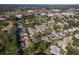 Aerial view of a home situated in a residential area with mature trees at 2468 Aster Dr, Palm Harbor, FL 34684