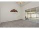 Bright bedroom with grey carpet and sliding doors to patio at 2468 Aster Dr, Palm Harbor, FL 34684