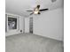 Well-lit bedroom with ceiling fan, carpet, and built-in shelving at 3301 Alt 19 # 252, Palm Harbor, FL 34683