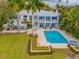 Private backyard with in-ground pool, hot tub, and lush tropical landscaping at 334 Blanca Ave, Tampa, FL 33606