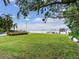 Private backyard with lush lawn, dock, and waterfront views at 334 Blanca Ave, Tampa, FL 33606