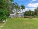 Spacious backyard with lush landscaping and a view of the home's exterior at 334 Blanca Ave, Tampa, FL 33606