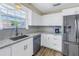 Bright kitchen with white cabinets, granite countertops, and stainless steel sink at 3515 41St S Ter # 221, St Petersburg, FL 33711