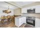 Eat-in kitchen, granite countertops, stainless steel appliances, and wood flooring at 3515 41St S Ter # 221, St Petersburg, FL 33711