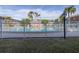 Community pool with a white fence and surrounding lawn at 3515 41St S Ter # 221, St Petersburg, FL 33711