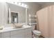 Bathroom with white vanity, stone sink, and shower at 3804 N Arlington Ave, Tampa, FL 33603