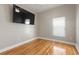Bedroom with hardwood floors and large wall-mounted TV at 3804 N Arlington Ave, Tampa, FL 33603