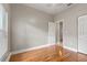 Bedroom featuring hardwood floors and an adjacent door at 3804 N Arlington Ave, Tampa, FL 33603