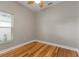 Simple bedroom with hardwood floors and a ceiling fan at 3804 N Arlington Ave, Tampa, FL 33603