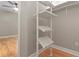 White shelving system in a closet with hardwood floors at 3804 N Arlington Ave, Tampa, FL 33603