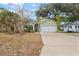 Light green house with a white garage door and landscaping at 3804 N Arlington Ave, Tampa, FL 33603