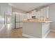 Kitchen with white cabinets, a breakfast bar, and tile floors at 3804 N Arlington Ave, Tampa, FL 33603