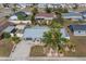 Aerial view showing a single story home with gray roof and palm trees at 411 Buttonwood Ct, Apollo Beach, FL 33572