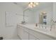 Clean bathroom with white vanity, large mirror, and updated fixtures at 433 S Paula Dr # 32, Dunedin, FL 34698