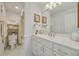 Bright bathroom with white vanity, decorative mirror, and shower with tub at 433 S Paula Dr # 32, Dunedin, FL 34698