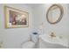 Powder room features a classic sink, gold hardware, and decorative artwork at 433 S Paula Dr # 32, Dunedin, FL 34698