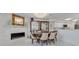 Dining room featuring a stone fireplace, display cabinet and contemporary chandelier at 433 S Paula Dr # 32, Dunedin, FL 34698
