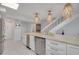 Updated kitchen boasts stainless steel appliances, white cabinetry, and marble countertops at 433 S Paula Dr # 32, Dunedin, FL 34698