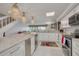Open kitchen with marble countertops, stainless appliances, and adjacent living space at 433 S Paula Dr # 32, Dunedin, FL 34698