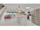 Modern kitchen with white cabinets, stainless steel appliances, and a large island at 433 S Paula Dr # 32, Dunedin, FL 34698