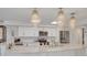 Bright kitchen with stainless steel appliances, marble countertops, and modern pendant lights at 433 S Paula Dr # 32, Dunedin, FL 34698
