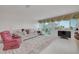 Bright living room with comfortable seating, a large window, and tiled floors at 433 S Paula Dr # 32, Dunedin, FL 34698