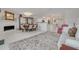 Open-concept living and dining area with stone fireplace and modern lighting at 433 S Paula Dr # 32, Dunedin, FL 34698