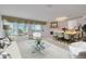 Bright living room featuring water view, modern furniture, and adjacent dining area at 433 S Paula Dr # 32, Dunedin, FL 34698