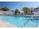 Community pool with an American flag flying in the background at 433 S Paula Dr # 32, Dunedin, FL 34698
