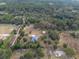 Aerial view showcasing a house, detached barn, and sizable property at 4347 Eva Lou Dr, Brooksville, FL 34602