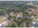 Aerial view of a house on a spacious lot with surrounding trees and gardens at 4347 Eva Lou Dr, Brooksville, FL 34602