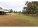 Open pasture with a wooden fence and mature trees at 4347 Eva Lou Dr, Brooksville, FL 34602