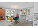 Casual dining area with colorful chairs, tile-top table, and modern lighting at 4514 Superior Ln, Clearwater, FL 33762