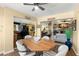 Bright dining area with wood table, view into living room and kitchen at 480 Winding Willow Dr, Palm Harbor, FL 34683