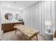 Relaxing spa area features a massage table, wood cabinet and two round decorative mirrors at 5120 Marina Way # 112, Tampa, FL 33611