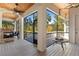 Relaxing screened porch with fireplace, ceiling fan, and wooded views at 6099 Summit View Dr, Brooksville, FL 34601