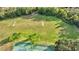 Community field with soccer goals, tennis court, and lush landscaping at 6508 S Grazing Ln, Odessa, FL 33556