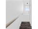 Modern staircase with metal railing and wood steps at 8600 N Rome Ave, Tampa, FL 33604