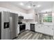 Well-equipped kitchen with stainless steel appliances and white cabinetry at 11008 Windsor Place Cir, Tampa, FL 33626