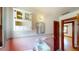 Bathroom featuring original sink, mirror, cabinet, and a doorway at 1149 Sedeeva St, Clearwater, FL 33755