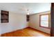 Bright bedroom features hardwood floors, built-in shelves, and a ceiling fan at 1149 Sedeeva St, Clearwater, FL 33755