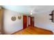 Cozy bedroom featuring hardwood floors, two closets and decorative mirrors at 1149 Sedeeva St, Clearwater, FL 33755