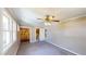Well-lit bedroom with carpet, ceiling fan, access to an en-suite bathroom, and window views at 1149 Sedeeva St, Clearwater, FL 33755