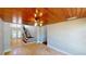 Open living room with wood ceilings, tile floors, and a staircase to the second floor at 1149 Sedeeva St, Clearwater, FL 33755
