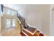 Wooden staircase with iron railings leading to the second floor at 1149 Sedeeva St, Clearwater, FL 33755