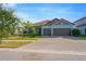 Single-story home with a two-car garage and paver driveway at 11926 Cinnamon Fern Dr, Riverview, FL 33579